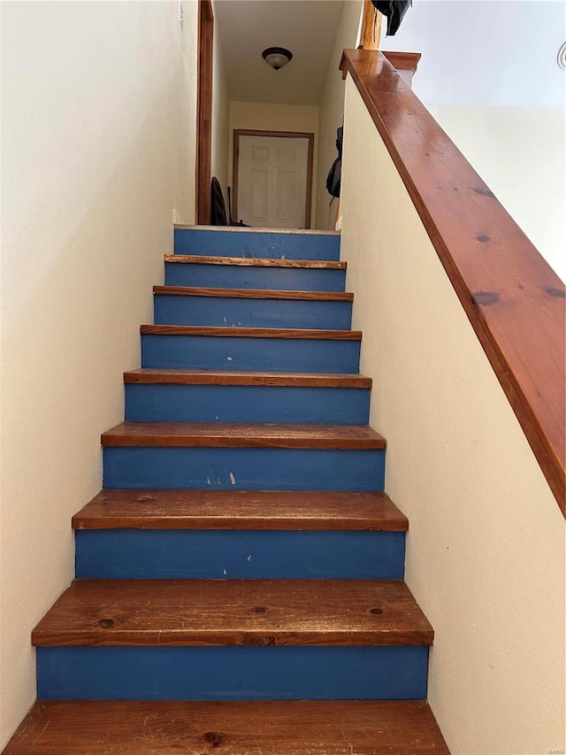 stairway featuring wood finished floors