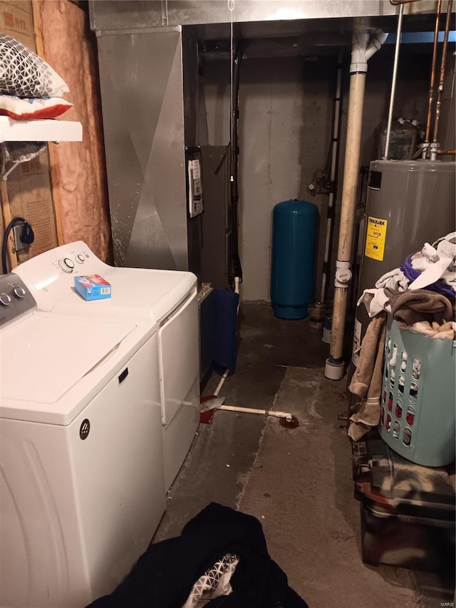 clothes washing area featuring laundry area, water heater, and washing machine and clothes dryer