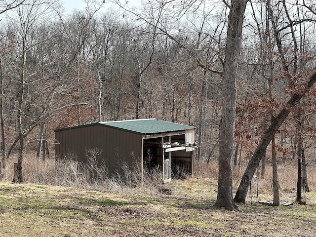 view of pole building featuring a forest view