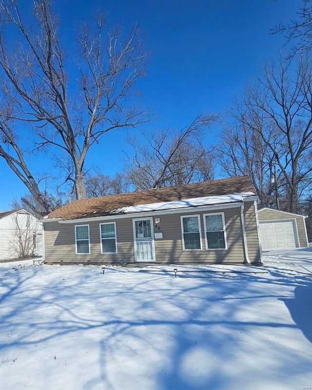 view of front of property with a garage and an outdoor structure