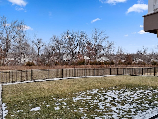 yard layered in snow with fence