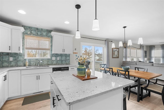 kitchen with white cabinetry, pendant lighting, and a center island