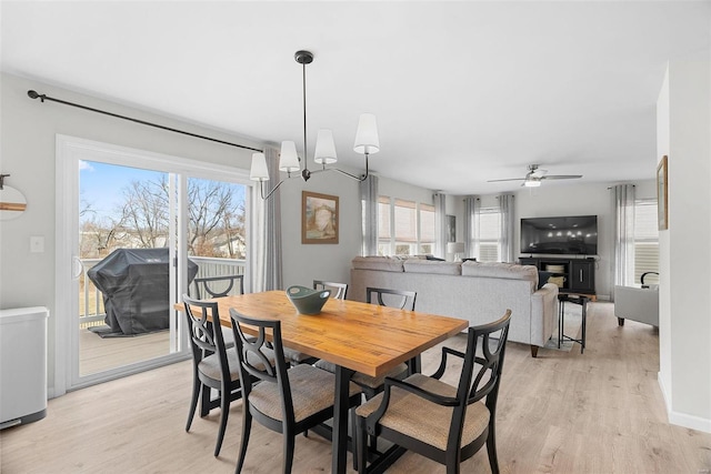 dining area with light wood-style floors and a ceiling fan