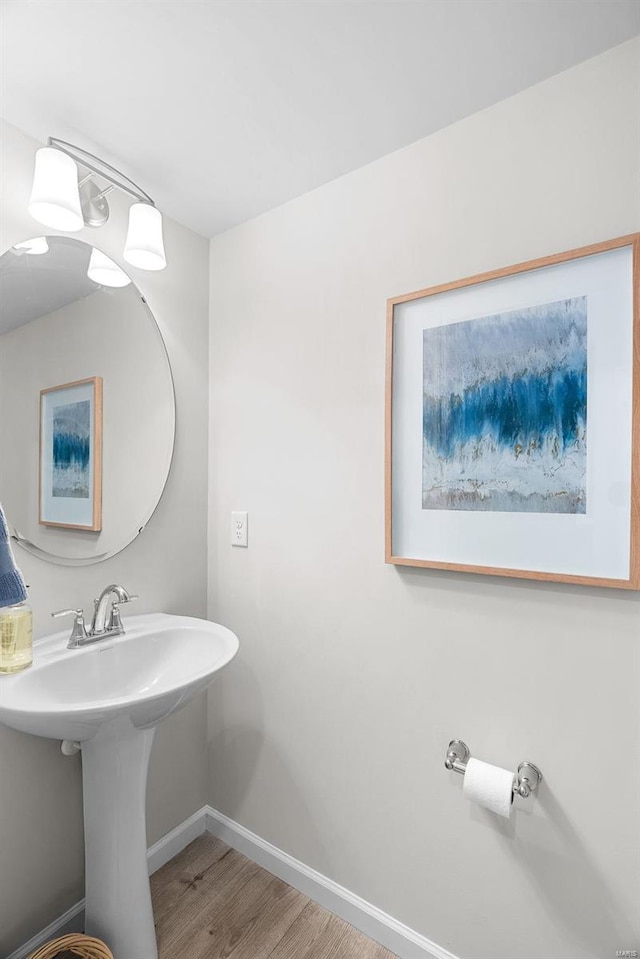 bathroom featuring baseboards and wood finished floors