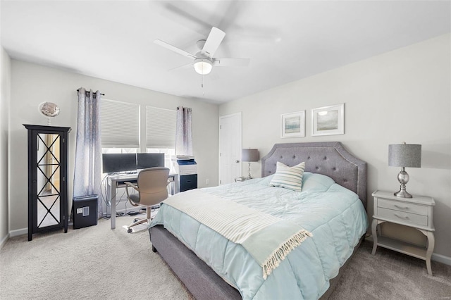 carpeted bedroom with ceiling fan and baseboards