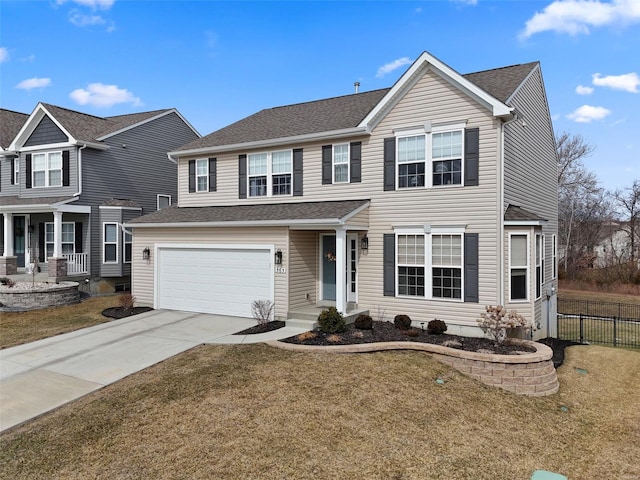 traditional-style house with a shingled roof, concrete driveway, an attached garage, a front yard, and fence