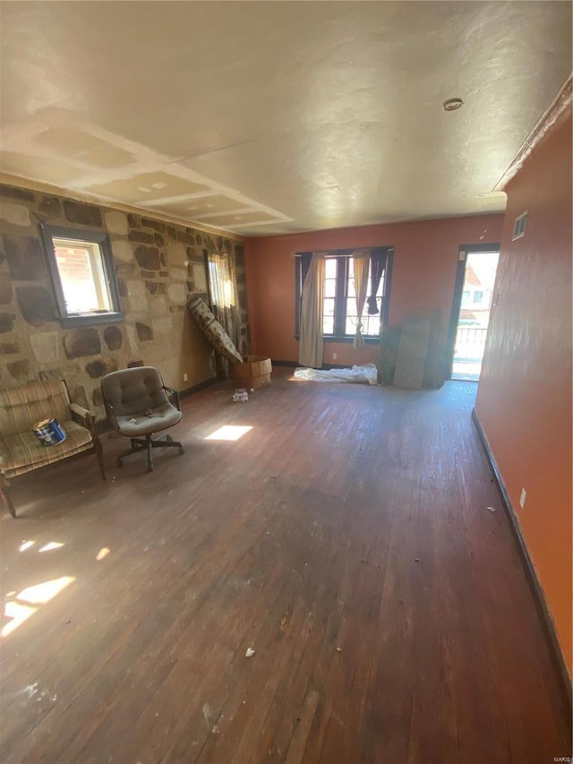 unfurnished living room featuring dark wood-style floors