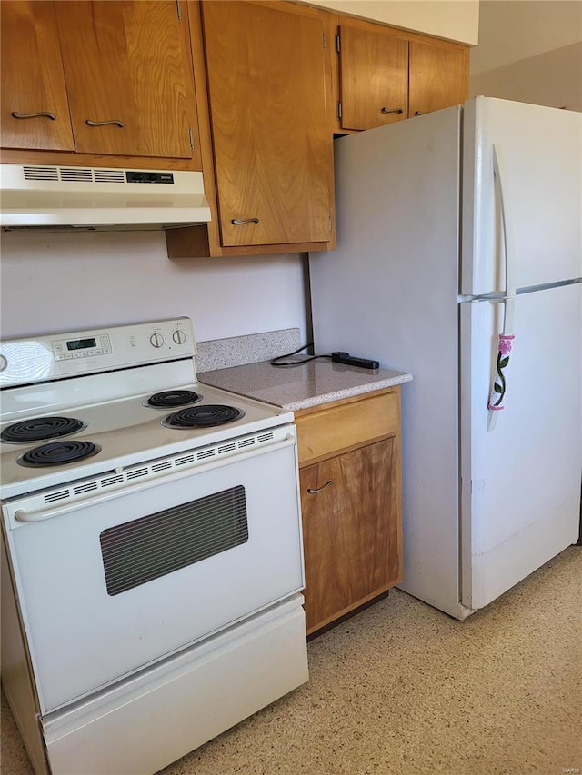 kitchen featuring under cabinet range hood, white appliances, light countertops, and brown cabinetry