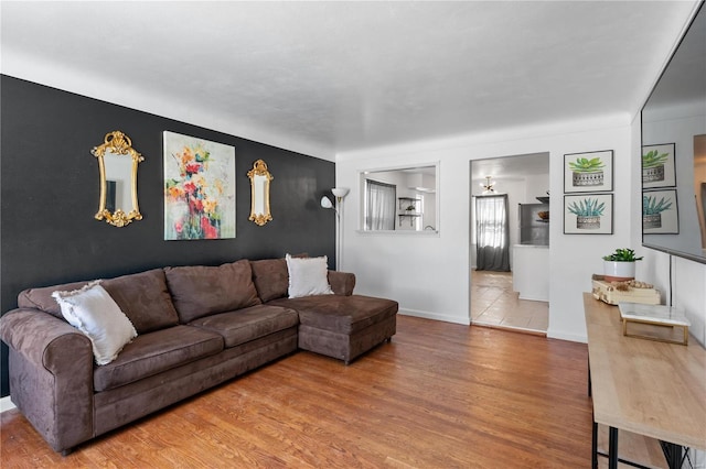 living room with baseboards and wood finished floors