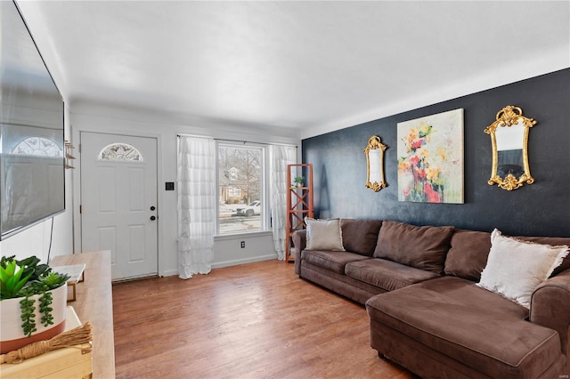 living area featuring baseboards and wood finished floors