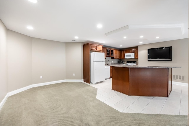 kitchen featuring visible vents, light carpet, recessed lighting, white appliances, and glass insert cabinets