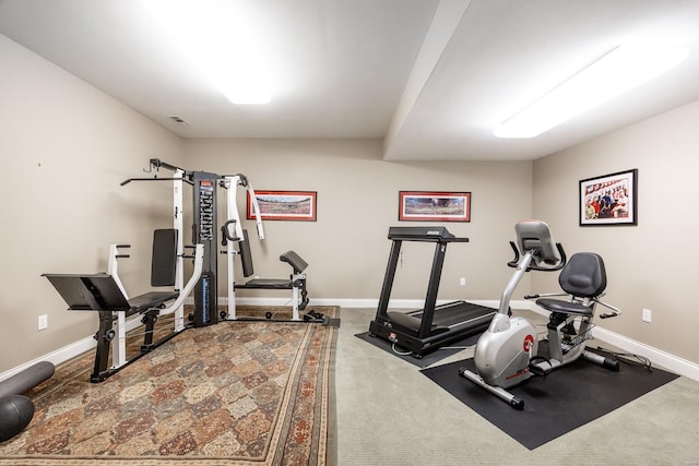 exercise room featuring visible vents, baseboards, and carpet floors