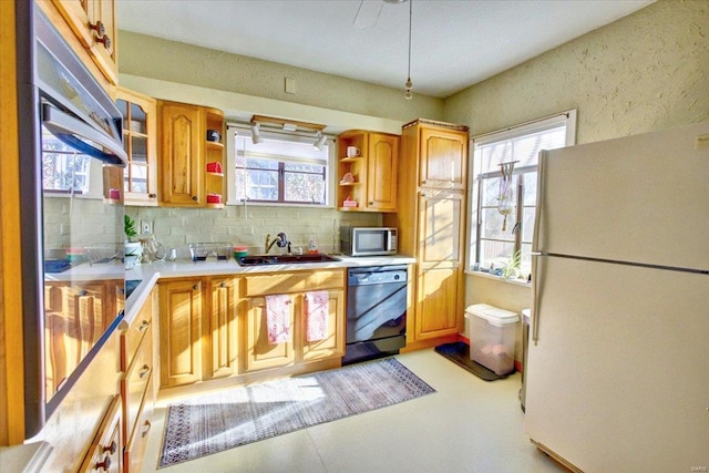 kitchen featuring dishwashing machine, freestanding refrigerator, open shelves, tasteful backsplash, and stainless steel microwave