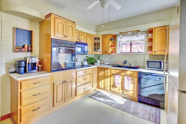 kitchen featuring open shelves, tasteful backsplash, light countertops, a sink, and black appliances