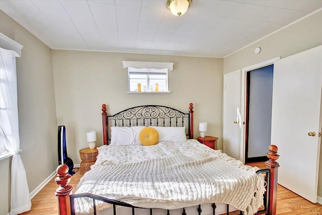 bedroom with light wood-style flooring and baseboards