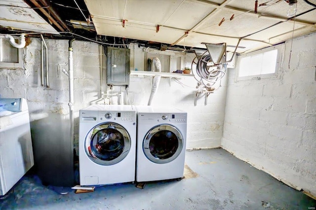 washroom with laundry area, washing machine and dryer, and electric panel