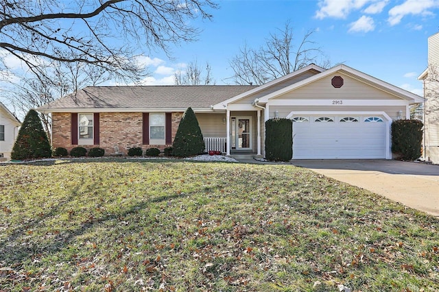 single story home with a front yard, concrete driveway, brick siding, and an attached garage