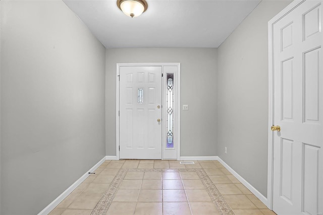 foyer entrance with baseboards and light tile patterned floors