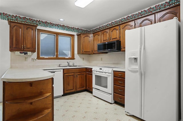 kitchen with light floors, open shelves, decorative backsplash, a sink, and white appliances