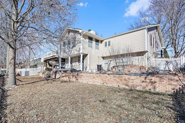 back of property featuring fence and a chimney