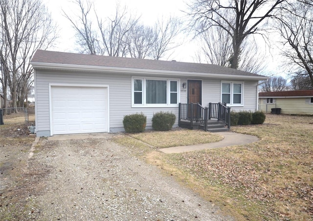 single story home with driveway, a shingled roof, and an attached garage