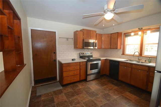 kitchen featuring stainless steel appliances, light countertops, a sink, and tasteful backsplash