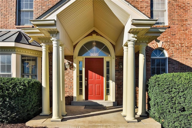 entrance to property with a standing seam roof and brick siding