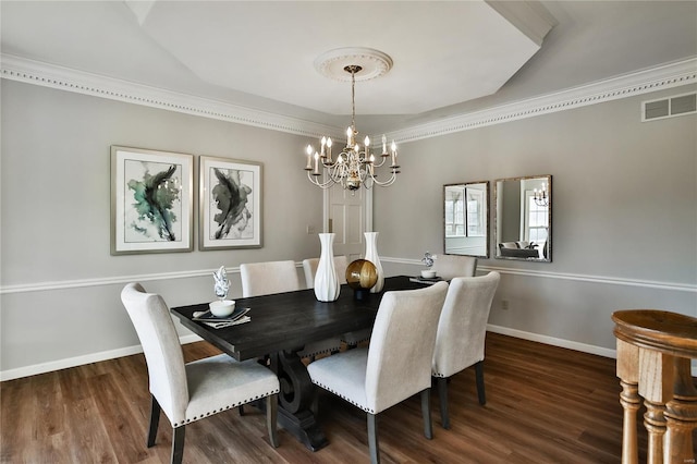 dining room featuring baseboards, visible vents, and wood finished floors