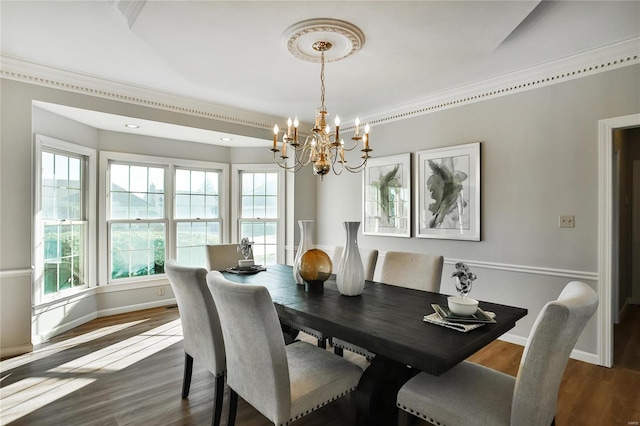 dining room featuring ornamental molding, dark wood finished floors, and baseboards