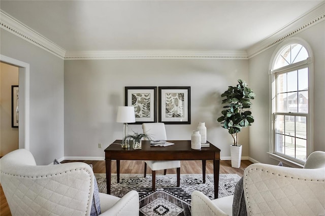 office area with ornamental molding, wood finished floors, and baseboards