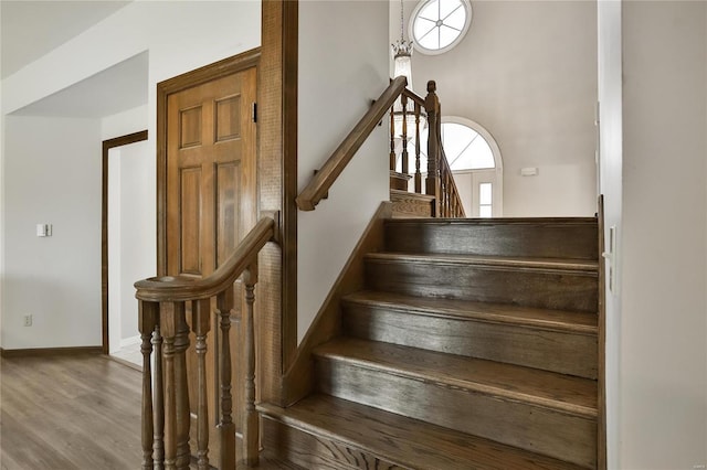 stairs with baseboards and wood finished floors