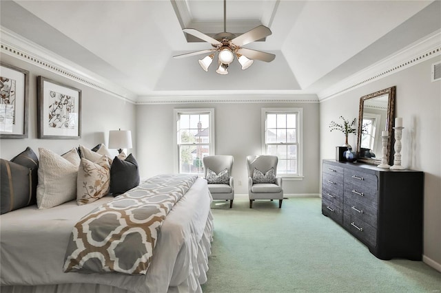 bedroom with a raised ceiling, light colored carpet, ornamental molding, a ceiling fan, and baseboards