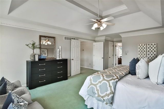 bedroom with visible vents, a tray ceiling, crown molding, and light colored carpet