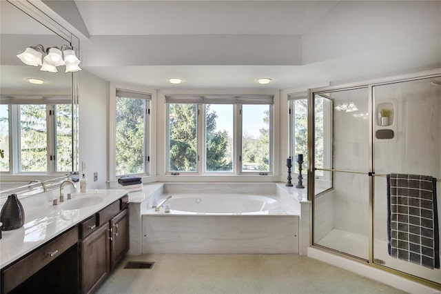 bathroom with visible vents, vanity, a shower stall, and a bath