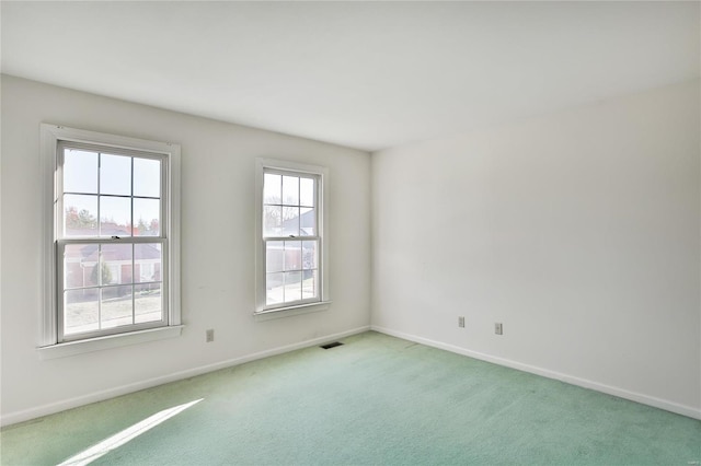 spare room with carpet and baseboards