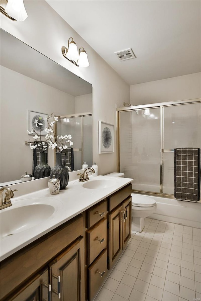 full bathroom featuring toilet, visible vents, a sink, and tile patterned floors