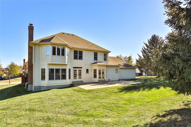 back of house with a yard, entry steps, french doors, and a patio