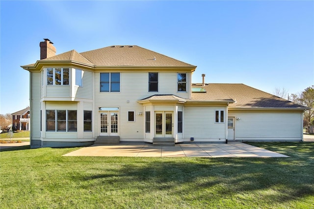 back of property featuring entry steps, french doors, a lawn, a chimney, and a patio area