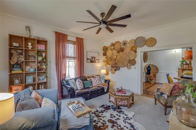 living area featuring a ceiling fan and crown molding