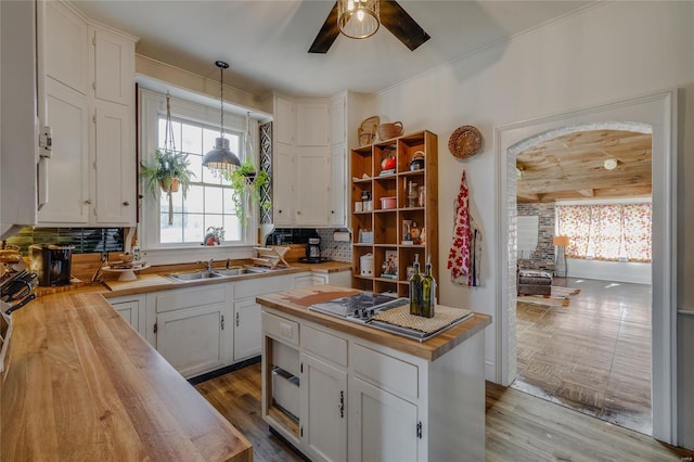 kitchen featuring white cabinets, wood counters, and wood finished floors