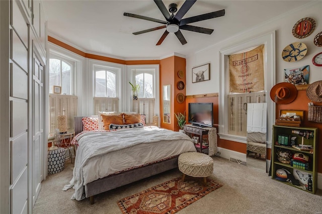 bedroom with ceiling fan, carpet, and ornamental molding