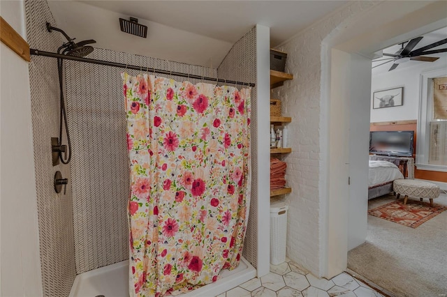 ensuite bathroom with a ceiling fan, a stall shower, and connected bathroom