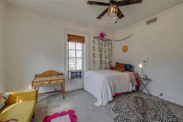 bedroom featuring visible vents, ceiling fan, ornamental molding, carpet floors, and cooling unit