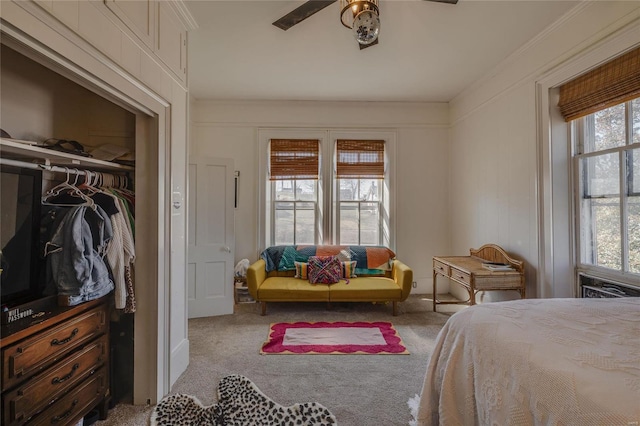 carpeted bedroom with a closet and ornamental molding