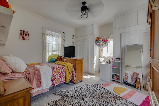 bedroom with ceiling fan, multiple windows, light colored carpet, and ornamental molding