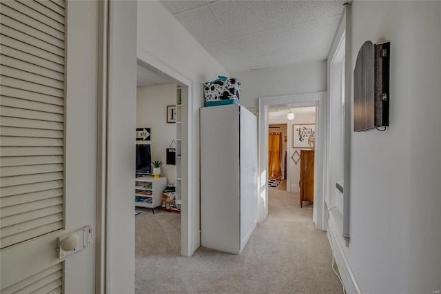 hall featuring light colored carpet