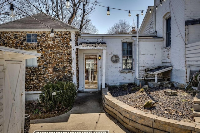 property entrance featuring brick siding