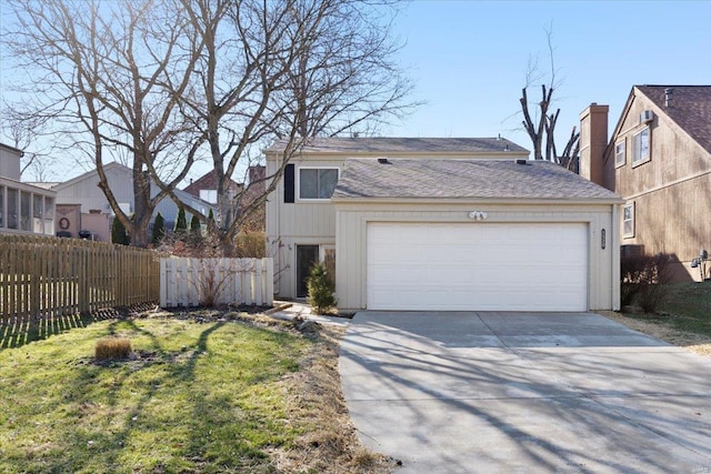 view of front of house featuring concrete driveway, an attached garage, and fence