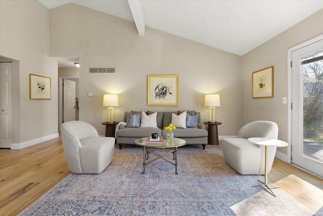 living room with visible vents, beam ceiling, high vaulted ceiling, wood finished floors, and baseboards