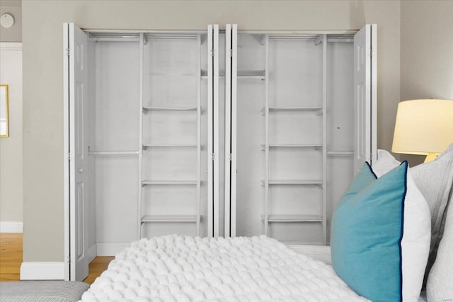 bedroom with wood finished floors and baseboards